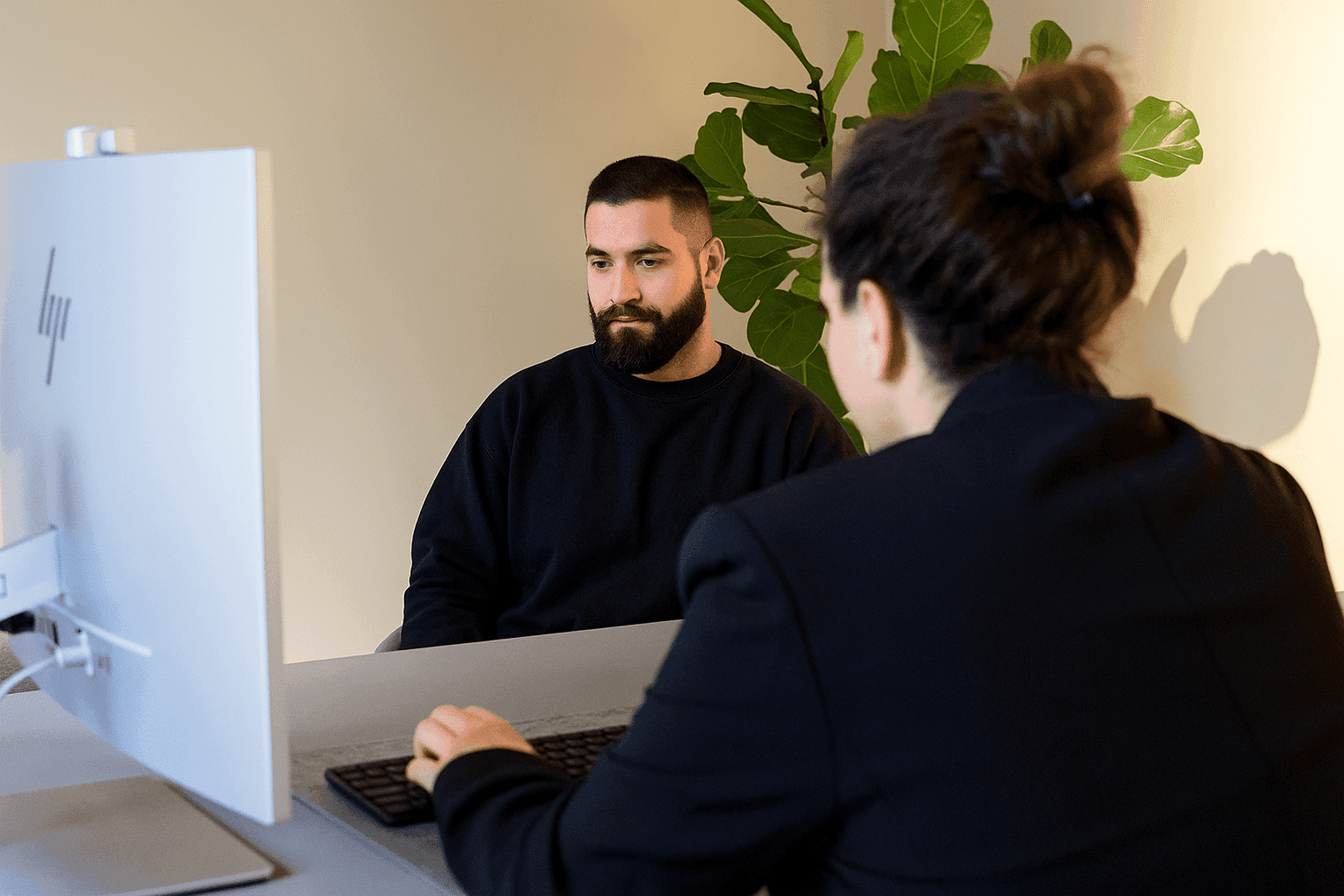 A person with a beard looking at a screen